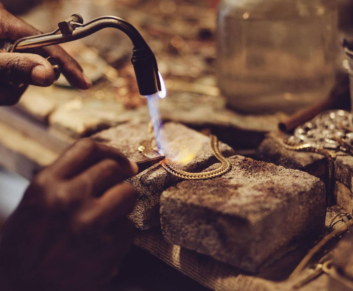 A jeweller setting stones into a ring by hand